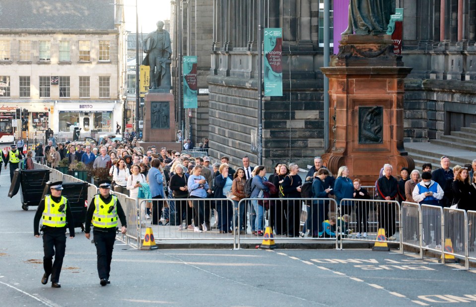 People queue outside St Giles’ Cathedral in Edinburgh to view the Queen's coffin today before it is moved to London