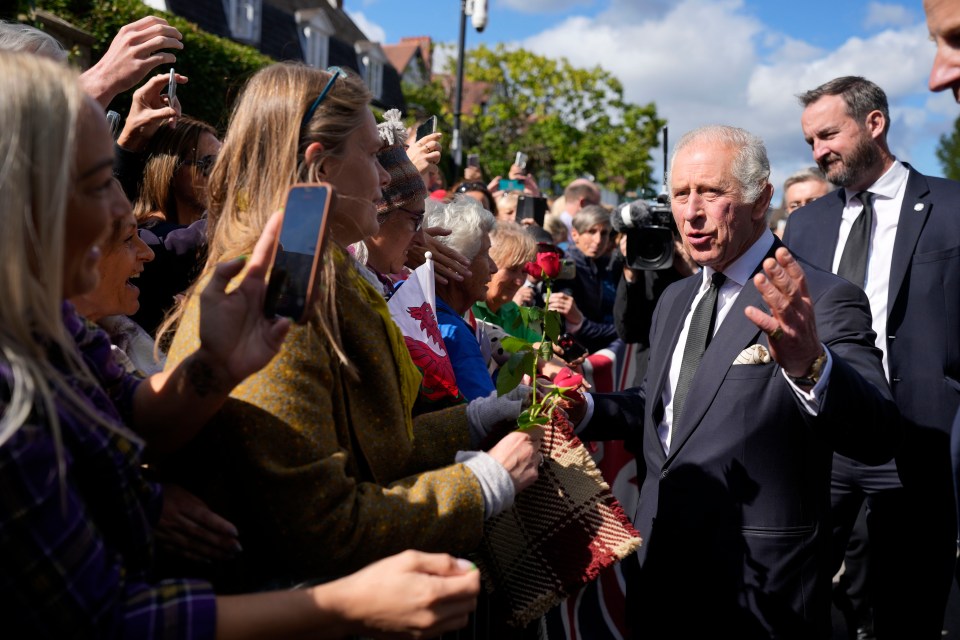 Charles was later handed two single red roses himself