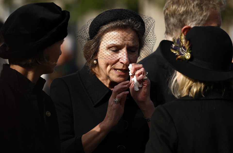 A woman weeps as the Queen’s cortège passes by in Ballater