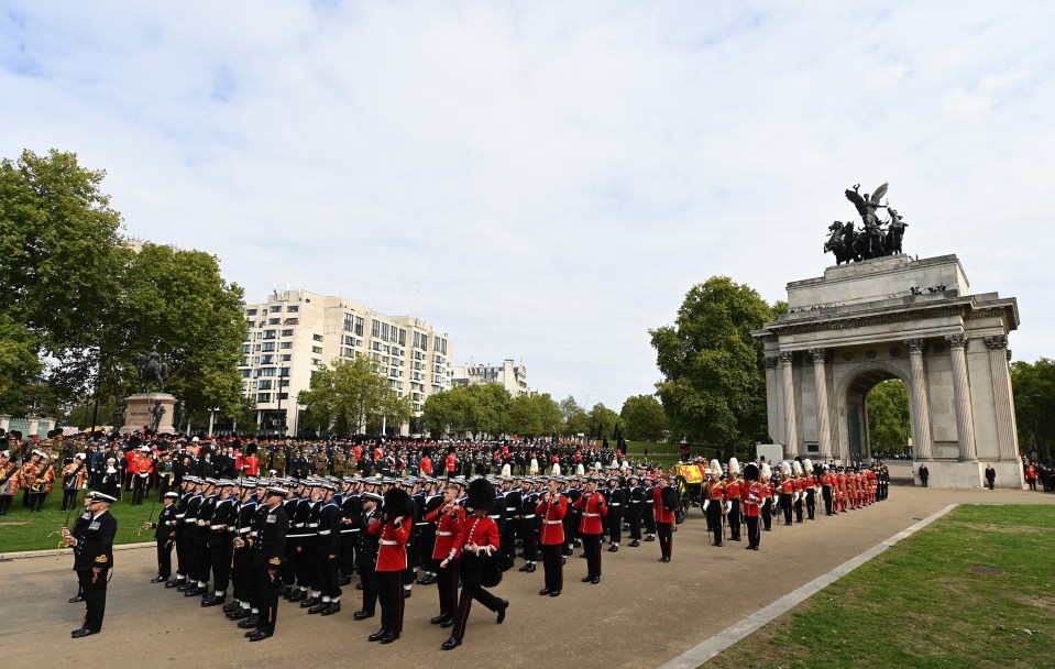 The Queen's coffin is seen passing Wellington Arch as thousands of mourners line the streets