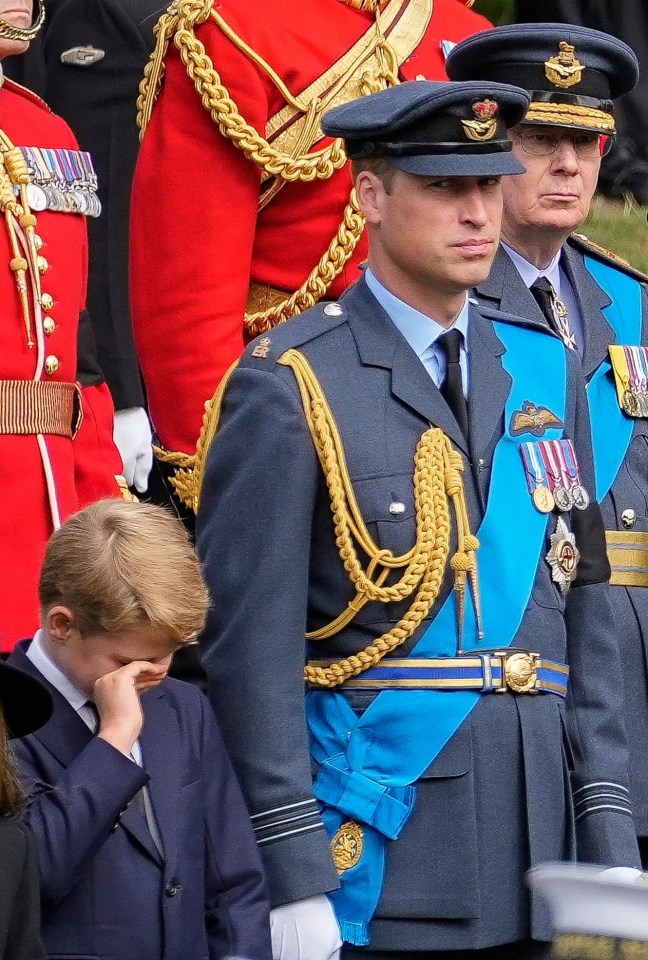 Prince George appeared to wipe away tears with his right hand before taking a deep breath and soldiering on, alongside father Prince William