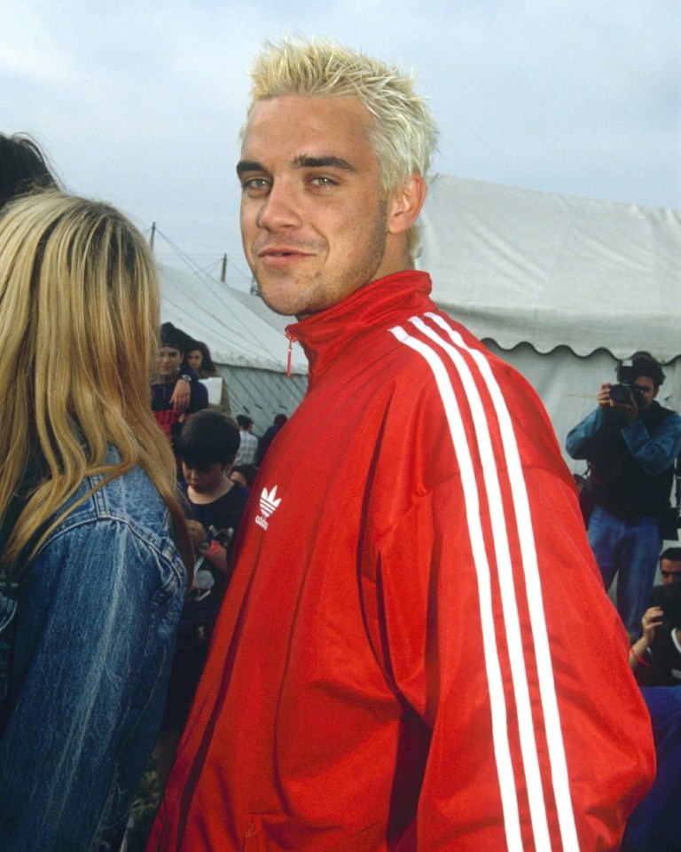 Robbie wearing his red Adidas tracksuit top at Glastonbury  in 1995