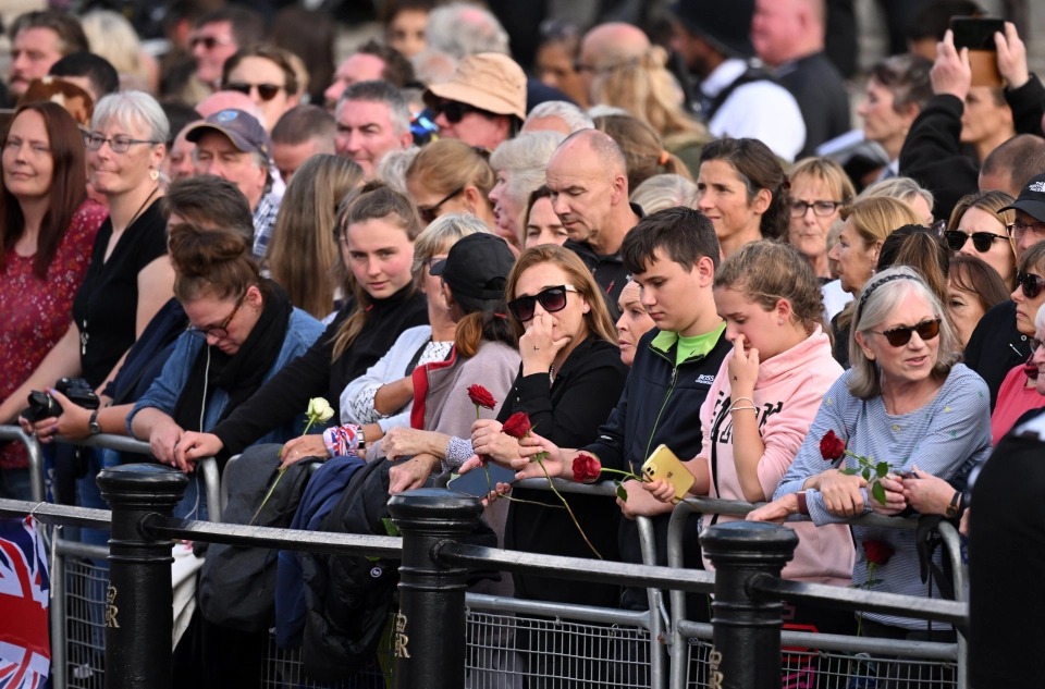 Mourners weep as the procession passes