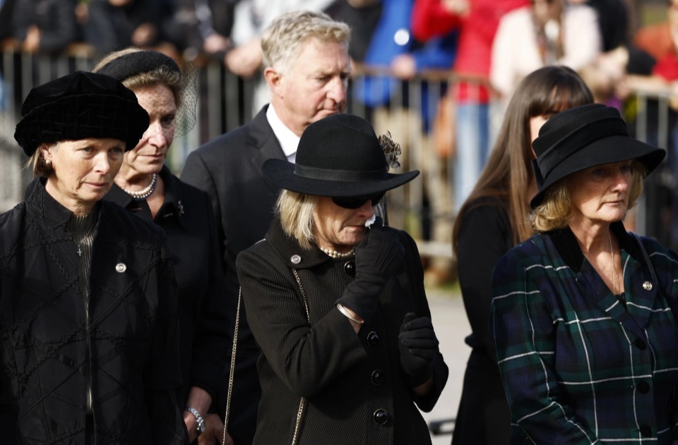 One woman wept as the coffin passed