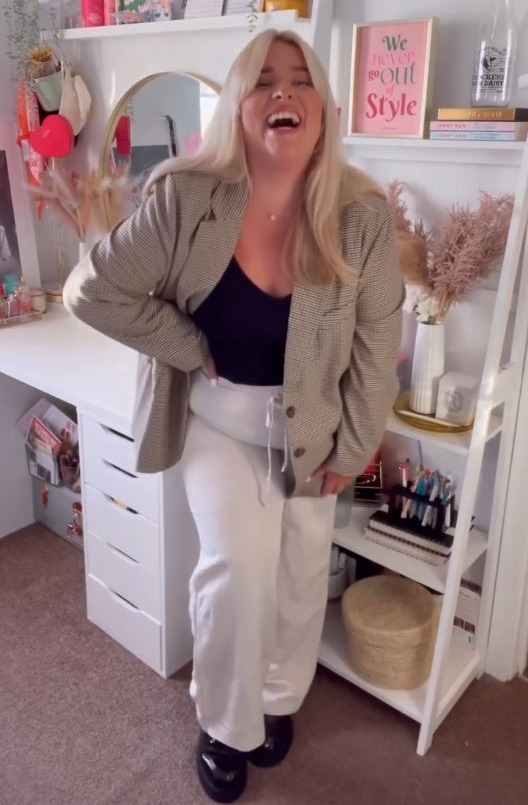 The fashionista was all smiles as she modelled chic oversized blazer and white linen pants