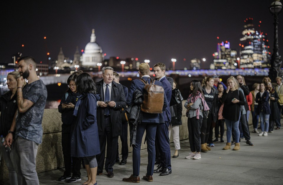 People standing along Southbank as they queue overnight