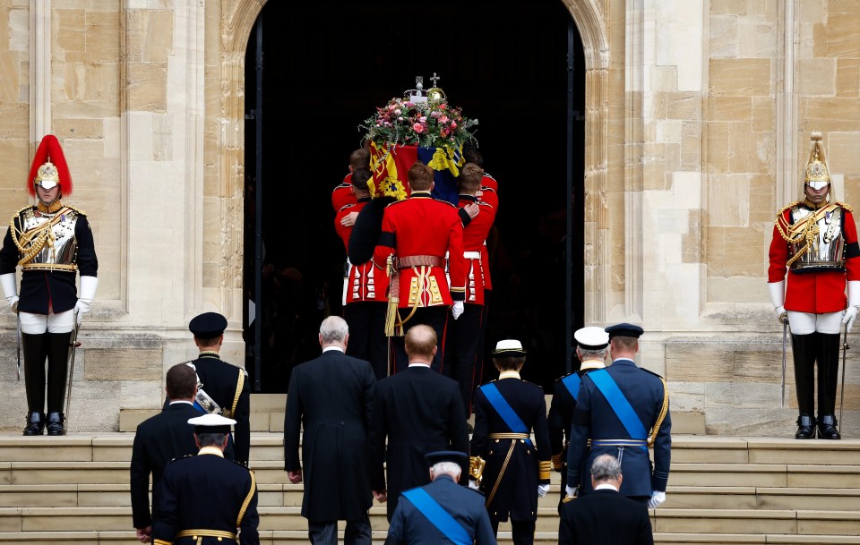 Pall bearers carry the Queen's coffin into St. George’s Chapel, followed by the Royal Family