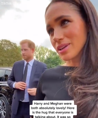 Harry can be seen in the background as Meghan talks to the young mourner