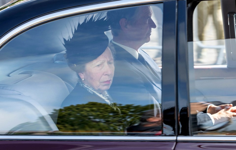 A sombre Princess Royal follows Her Majesty's hearse in a limo