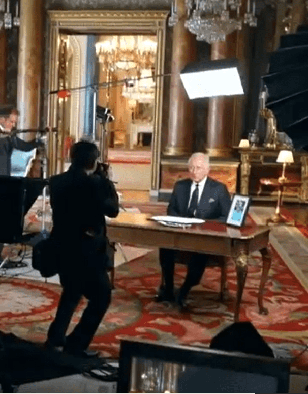 In the behind-the-scenes clip Charles is seen in the drawing room at Buckingham Places after making the moving address