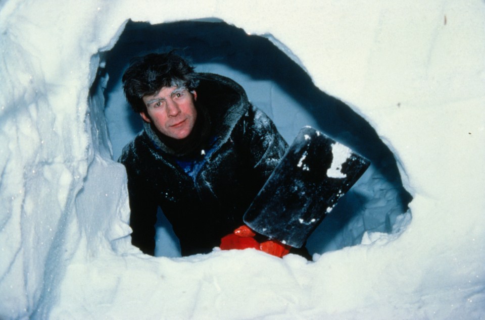 The explorer carves out an Antarctic snow hut in 1979