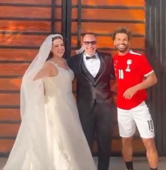 Mo Salah poses with a happy couple