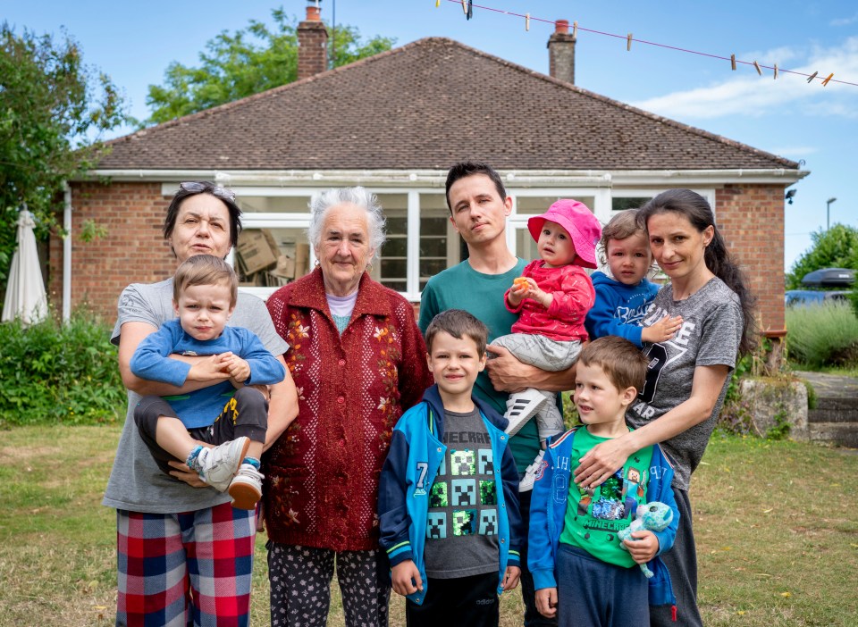 Maxim and Olga Hyryk pictured  with their five children and elderly mum outside the bungalow in Fareham, Hants