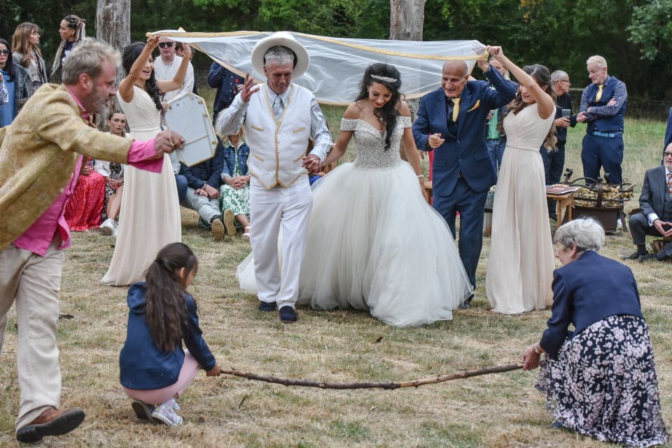 The pair jumped over a stick in a recreation of a pagan wedding ritual