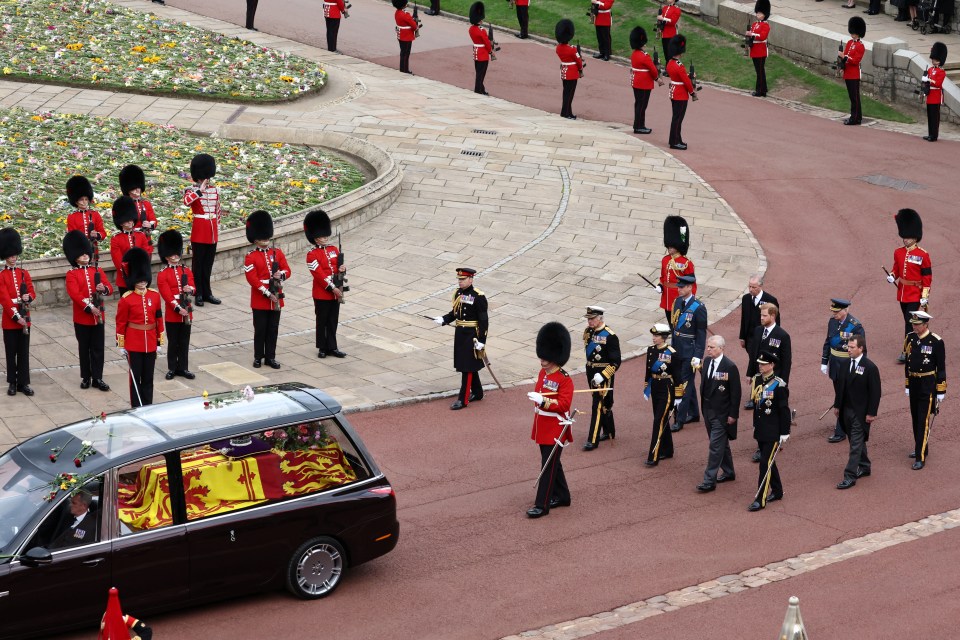 The Queen's children and some of her grandchildren follow the hearse carrying her  coffin