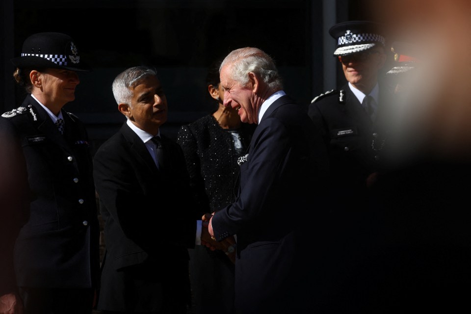 The monarch shaking hands with London Mayor Sadiq Khan during the visit