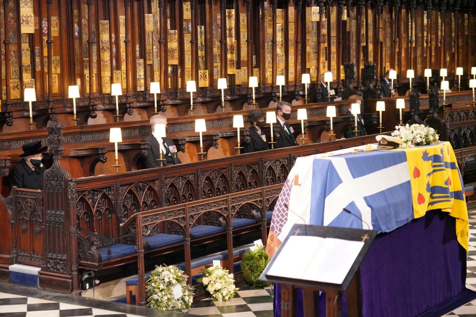 Queen Elizabeth II looks at the coffin of her husband, Prince Philip, who died at the age of 99 on April 17, 2021