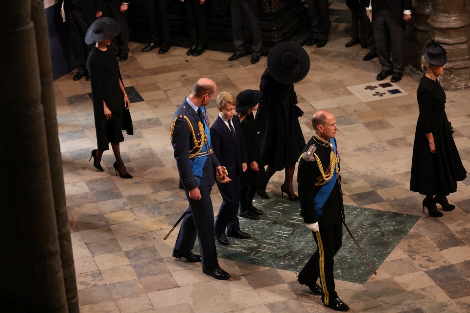 The nine-year-old appeared to be saying something to his father as they walked into Westminster Abbey