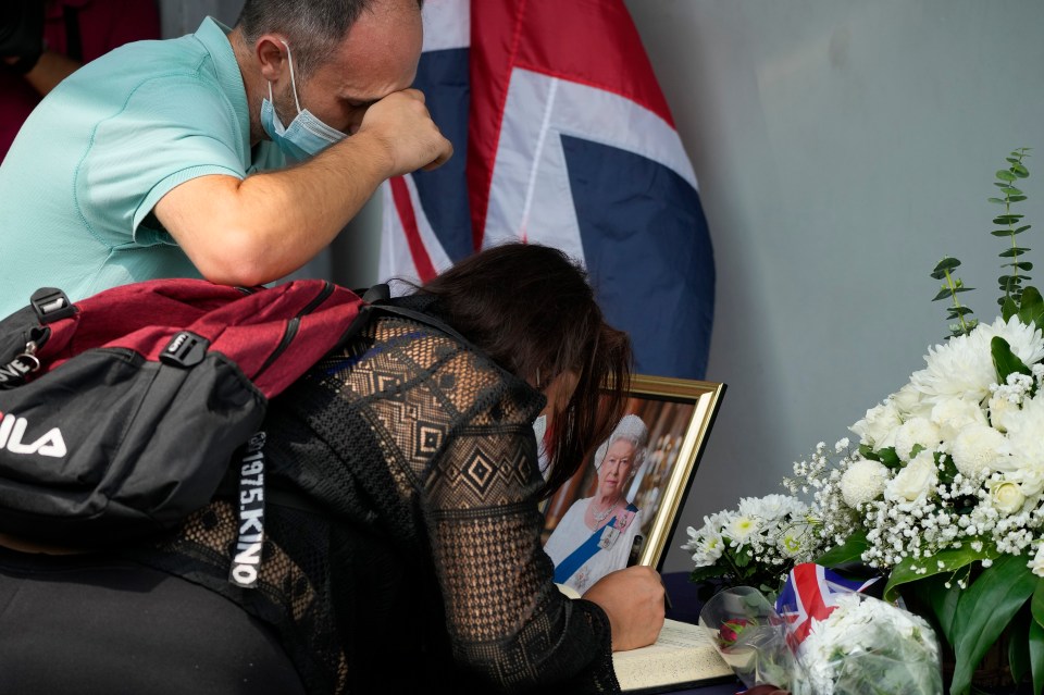 Emotional tourists sign the Book of Condolence outside the British Embassy in Manila in the Philippines