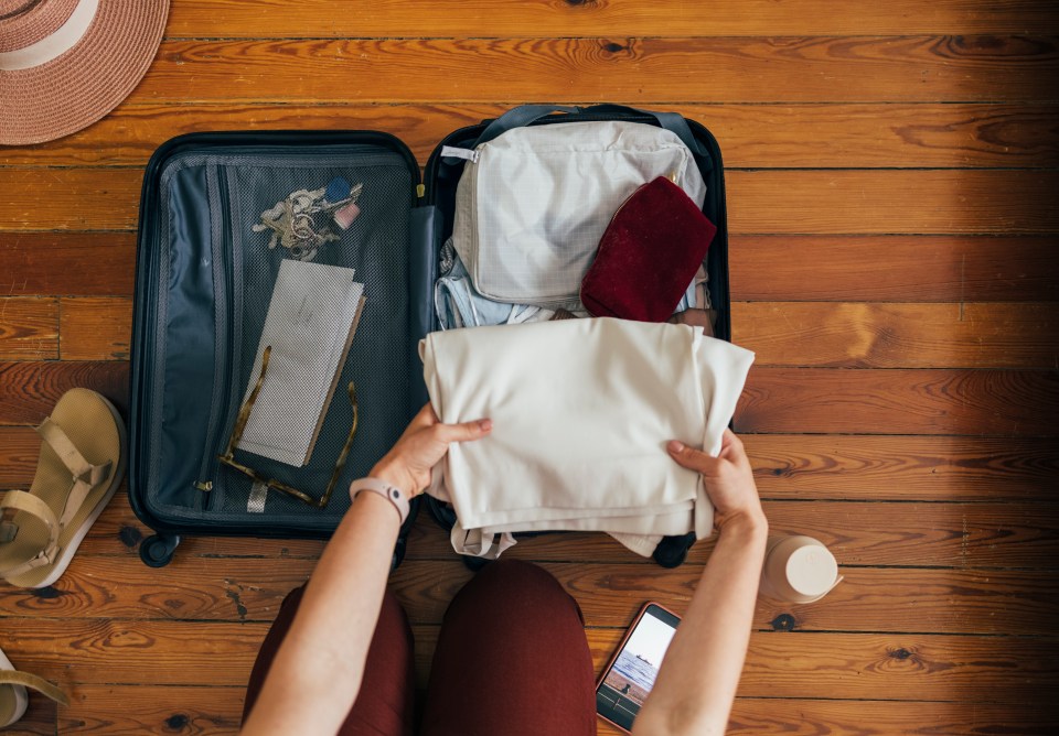 Sophie recommends using both folding and rolling clothes to fit more into a suitcase