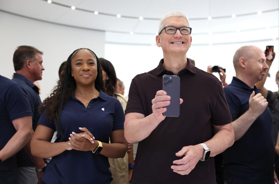 Apple boss Tim Cook holds an iPhone 14 Pro during Tuesday's event