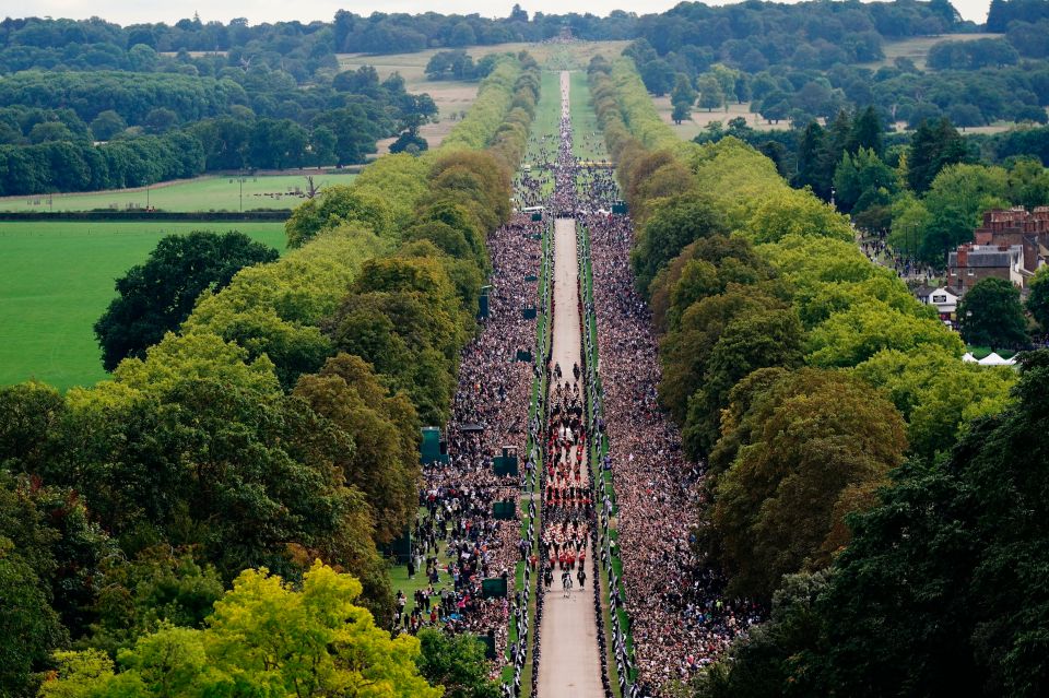 Thousands of people pay their last respects to the Queen as her coffin arrives at Windsor Castle