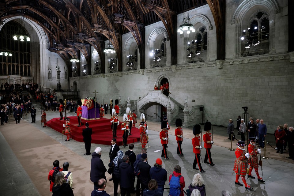 Members of the public pay their respects as they pass the Queen's coffin