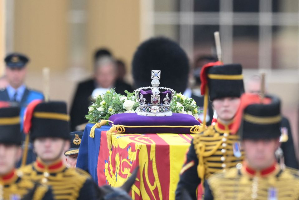 The Imperial Crown sat on top of a purple velvet pillow draped on the Queen's coffin