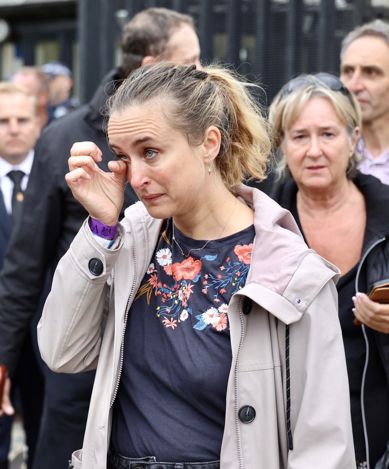 Overcome with emotion mourners dab tears on seeing Her Majesty's coffin