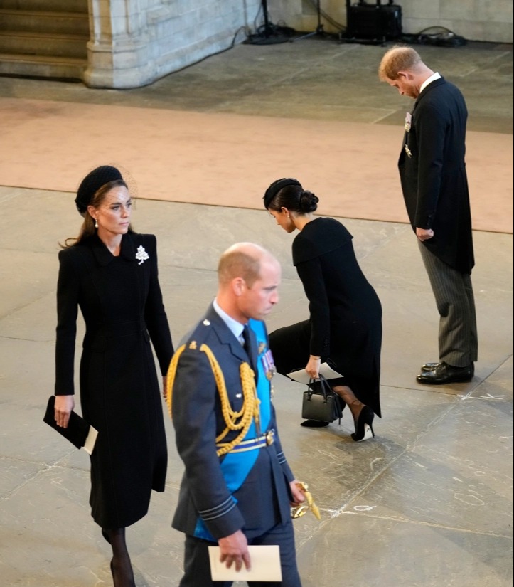 Meghan gives Her Majesty a low bow