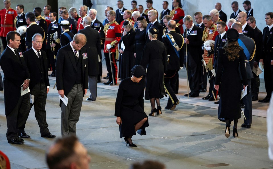 Prince Harry can be seen bowing behind his wife as she curtsies before the Queen's coffin