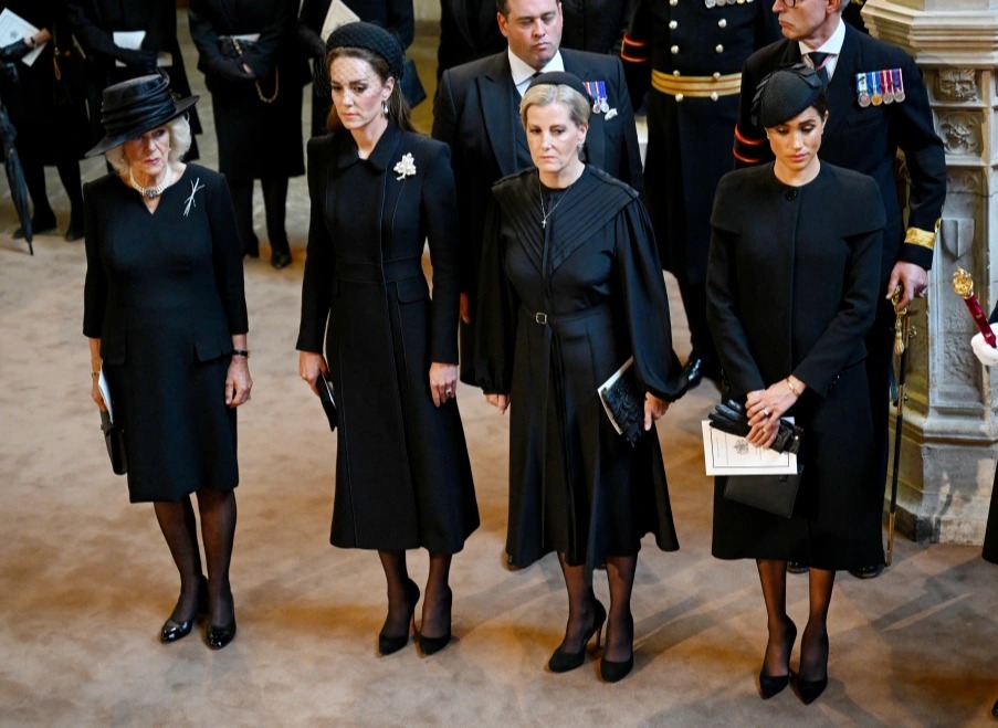 Camilla, Kate, Sophie and Meghan bow their heads as the coffin passes