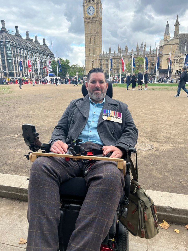 Wheelchair user Nick Wilson, a former soldier, struggled to his feet to salute the Queen for one last time