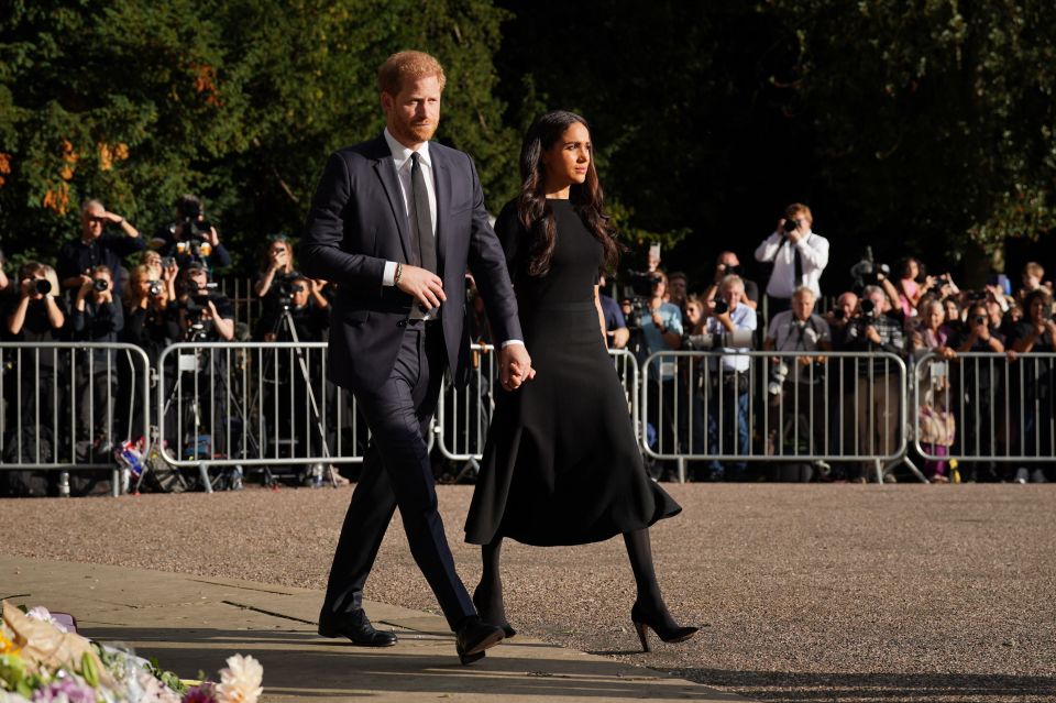 The Duke and Duchess of Sussex walk to meet members of the public at Windsor Castle in Berkshire