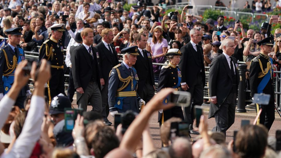 Royals walk behind the Queen's coffin, draped in the Royal Standard