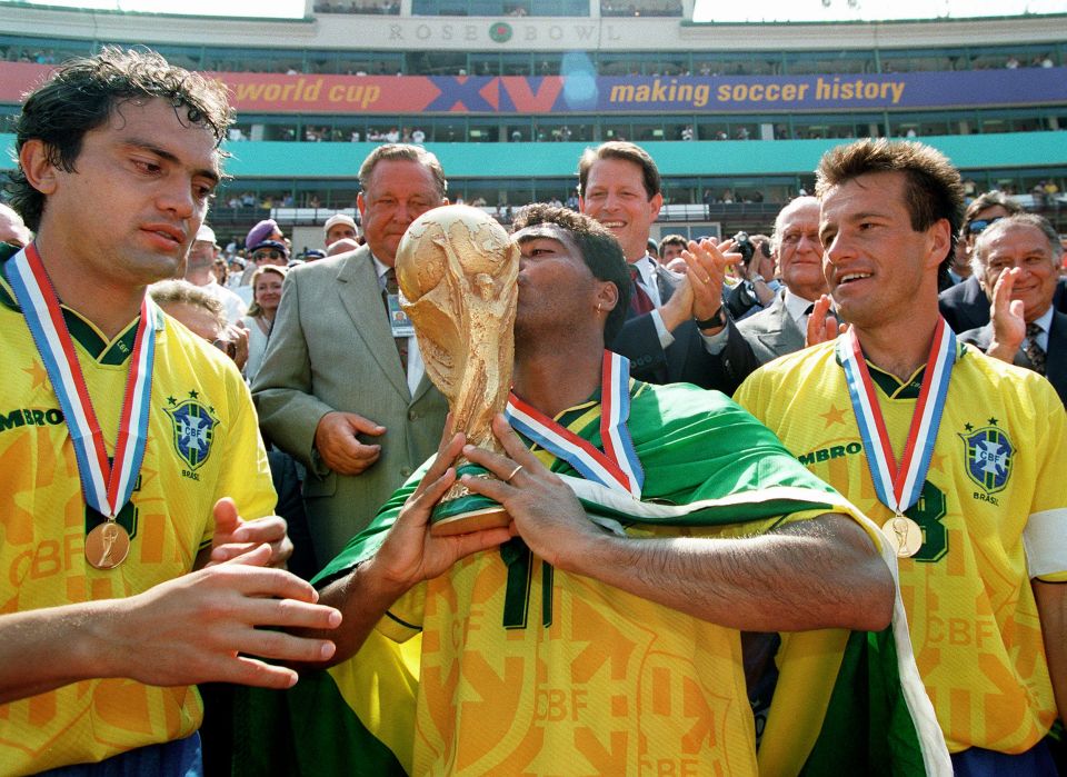 Brazilian forward Romario kisses the FIFA World Cup trophy after 1994 win