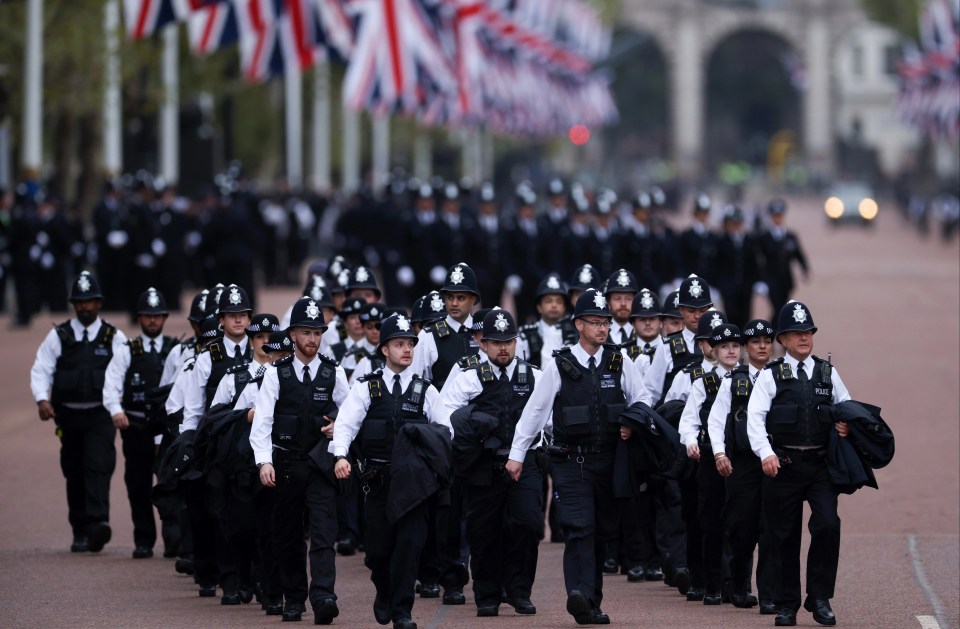 Metropolitan Police officers walking in formation down The Mall