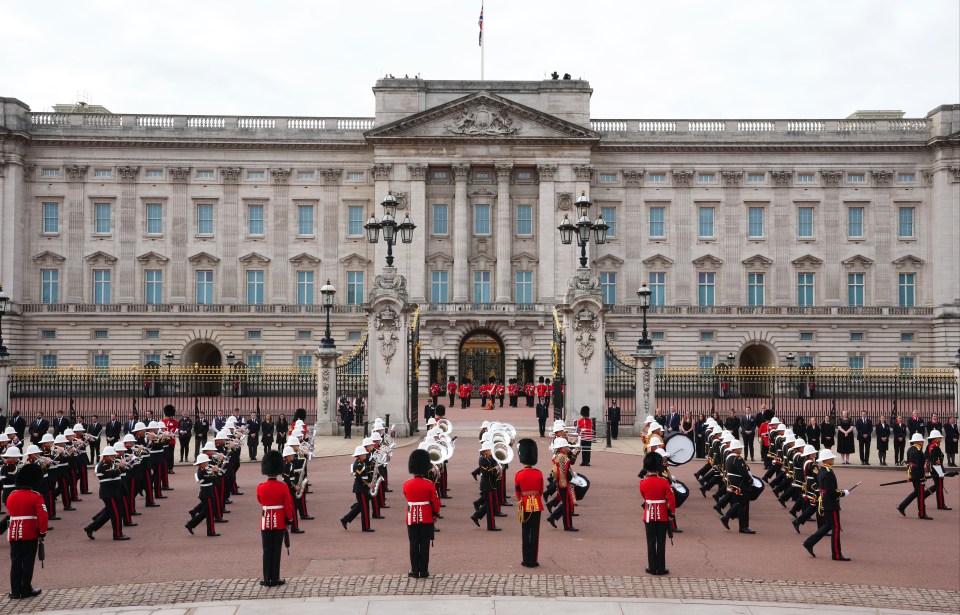 The Band of the Royal Marines passes by Buckingham Palace in the sombre procession