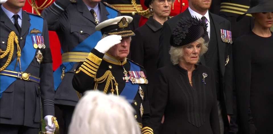 King Charles salutes as his mother's coffin is driven in the state hearse