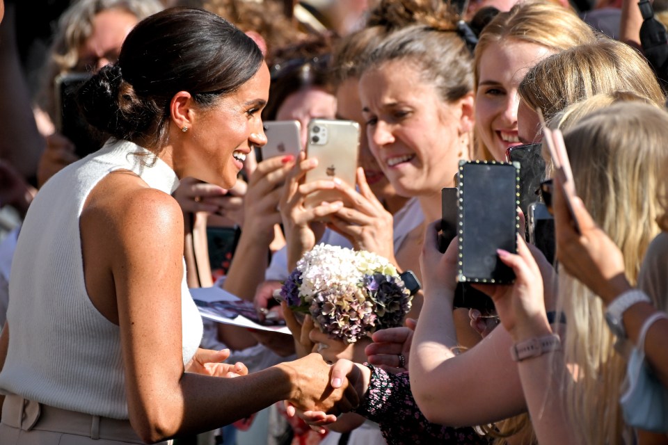 The Duchess of Sussex also shook hands with smiling fans