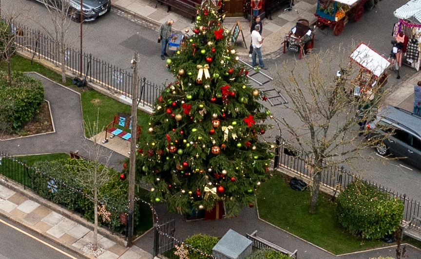 The tree has been adorned by baubles and decorations