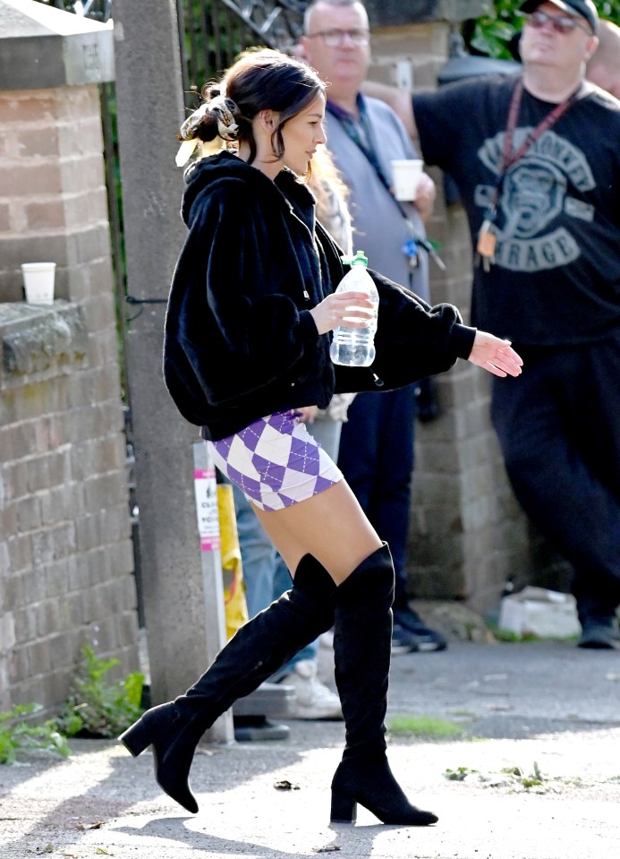 The actress kept hydrated while taking a break on set