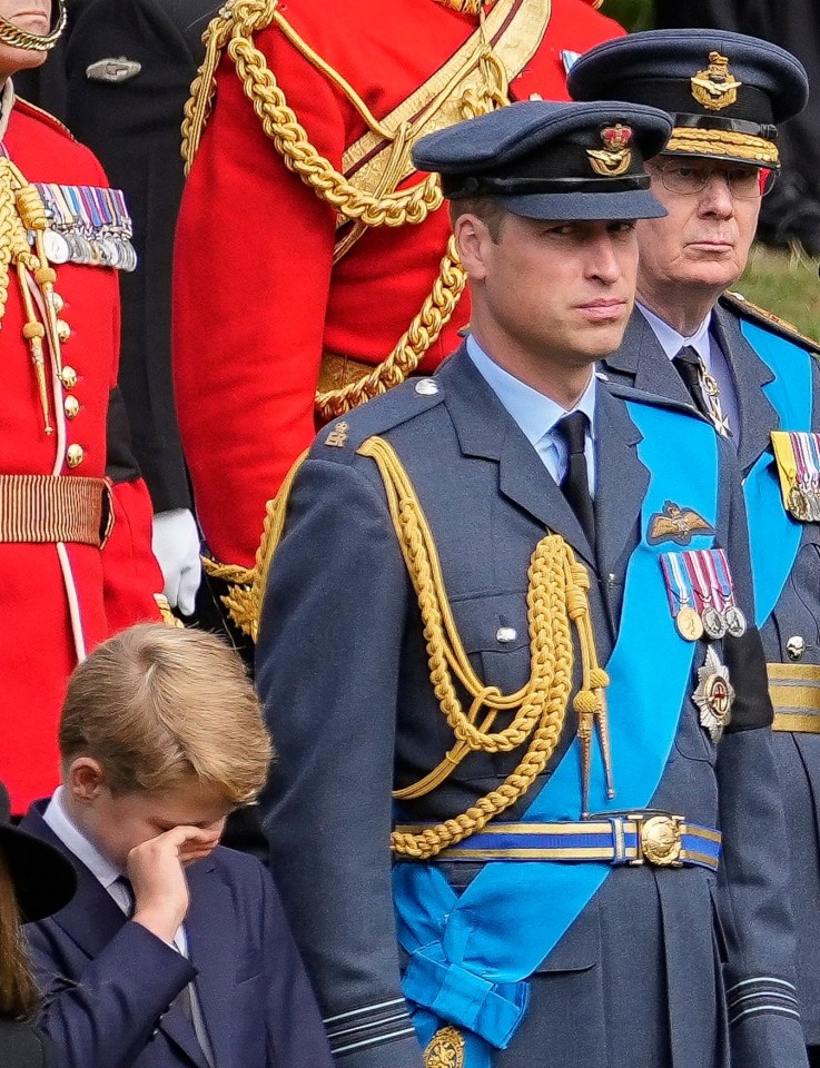 The young prince wipes his eyes as the Queen’s coffin is placed in a hearse