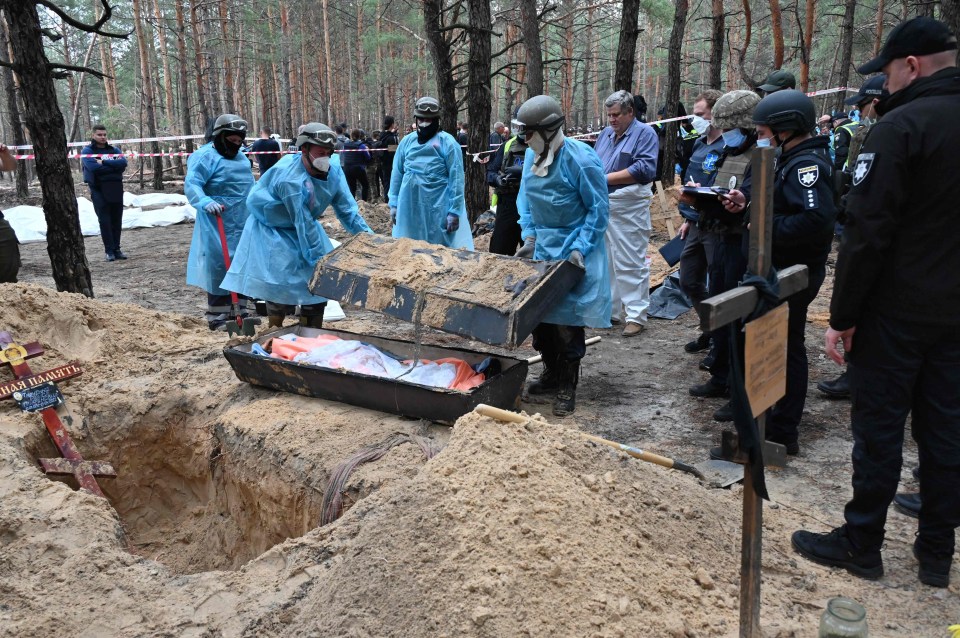 A coffin being opened after it was exhumed from a grave