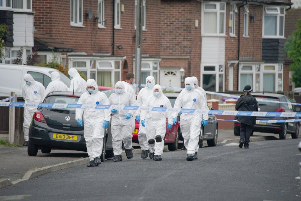 Forensics officers examining the area following the fatal shooting