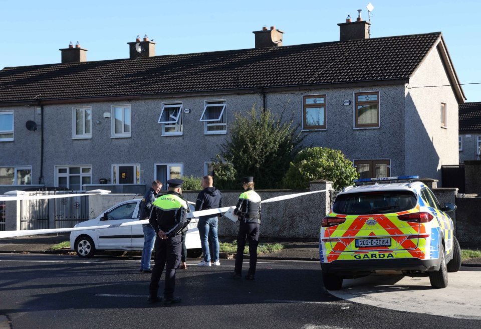 Police outside the house where three siblings were killed