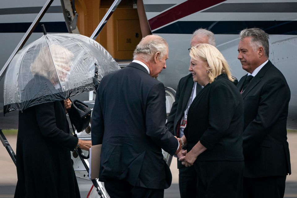 Charles appeared deep in conversation with the woman