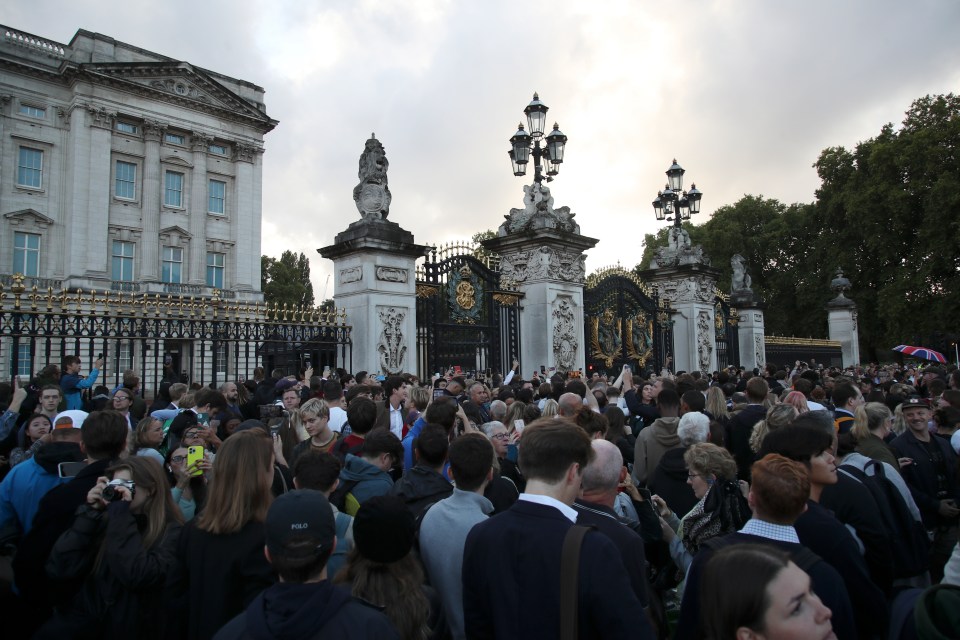 Mourners gather outside Buckingham Palace this evening