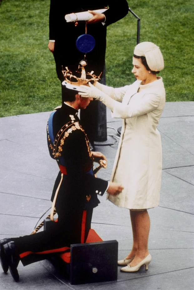 Her Majesty places a coronet on Charles during his investiture as Prince of Wales