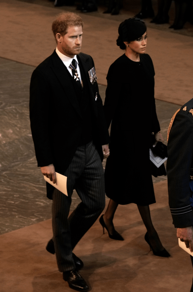 He held Meghan's hand as they left the Hall